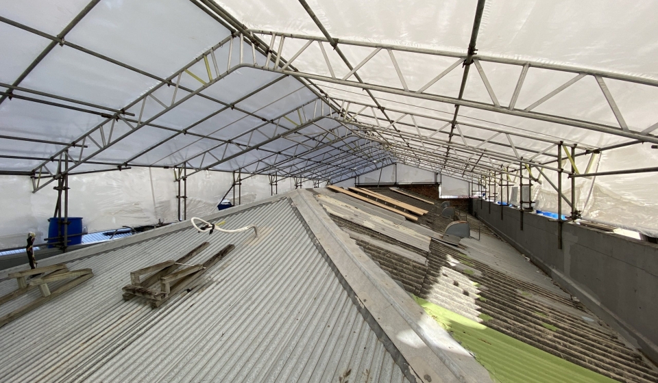 Asbestos cement roofing sheets being safely stripped and removed from an Auckland home